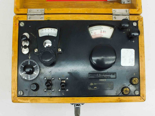 Leeds & Northrup 1138212 Millivolt Testing Unit MTR — top-down view of instrument panel inside open wooden case showing two analog meters, rotary controls, and terminal switches