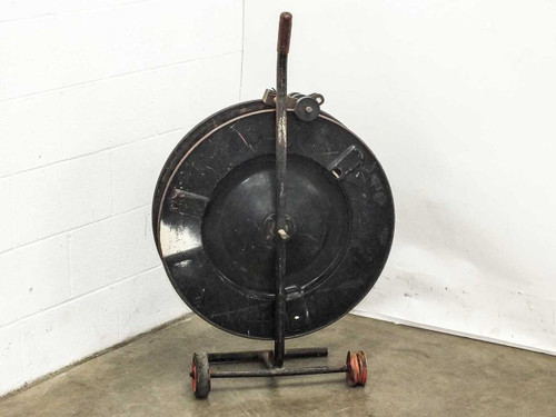 Signode DD-1A strapping dispenser — rear view showing reel housing back and steel axle with red wheels
