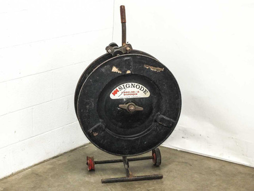Signode DD-1A mobile plastic strapping dispenser — front view showing circular reel housing, handle, and red wheeled base