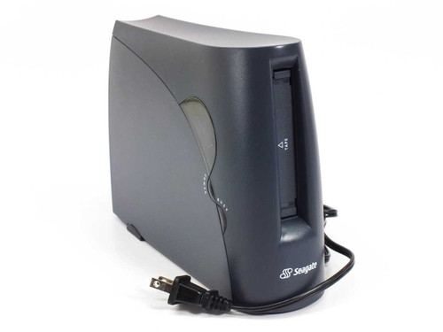Seagate STT6800P TapeStor external tape drive front and left side view showing dark charcoal enclosure, tape slot, activity indicator lights, and attached power cable