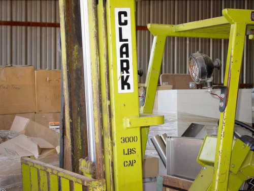 Clark Equipment mast close-up showing CLARK branding and 3000 LBS CAP rating plate on mast upright