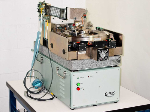 Guzik S1701 SpinStand Disk Drive Tester close-up showing spindle platter, actuator mechanism, and front control panel with Power and Start indicators