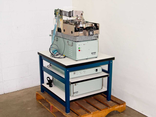 Guzik S1701 SpinStand Disk Drive Tester system on blue work table with RWA-1632 unit on lower shelf — full system view