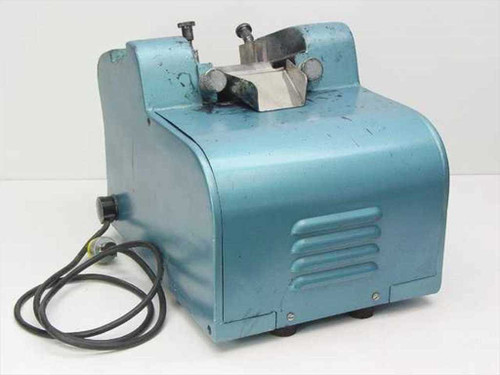 Burnett Bros Engineering industrial label applicator rear-right view showing vented blue housing and power cord routing