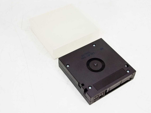 Fujifilm DLTtape IV cartridge bottom view showing tape reel hub and cartridge housing detail, dust cover beside it