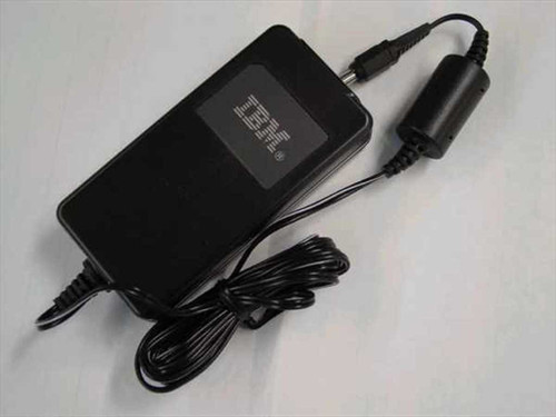 IBM 75H7522 AC Adapter top view showing IBM logo on black housing with barrel plug connector and attached AC cord