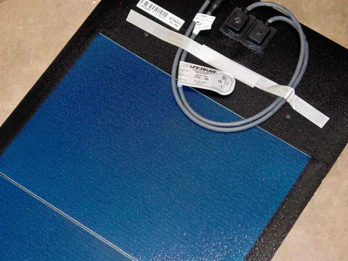 Uni-Solar PVL-68 flexible solar panel laid flat showing full blue laminate surface, MC3 cable, and product label