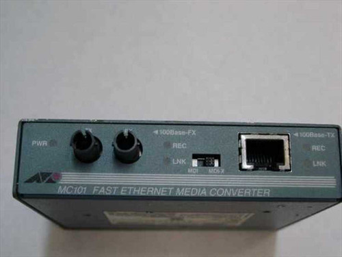 Allied Telesyn AT-MC101 front panel showing 100Base-FX ST fiber ports, PWR LED, 100Base-TX RJ-45 port, REC/LNK indicators, and MDI/MDIX switch