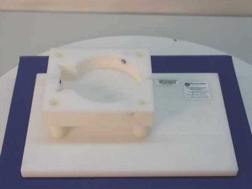 Pacesetter M16792 Delrin fixture — top view showing machined white Delrin clamp ring on flat base plate with label attached
