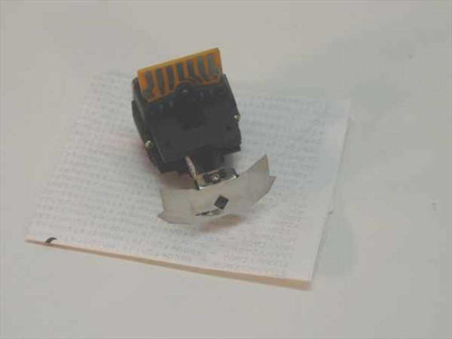 Prowriter 8510 9-pin dot matrix printhead assembly shown from above on a sheet of printed paper, with flex circuit connector visible at top