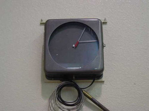 Dickson DT10 cryo-temperature chart recorder mounted on wall, front view showing circular chart face with recording arms and capillary tube coiled below