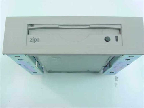 Iomega Z100iDE Zip 100 ATAPI drive installed in Compaq 5.25" metal bay mount bracket — front panel view showing Zip logo and eject button