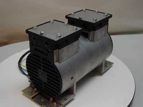 Tosei Engineering PSL-101A dual piston pump rear-left view showing black finned motor housing, dual cylinder heads with bolts, and mounting base plate