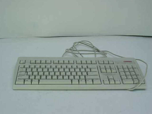 Compaq 166514-001 PS/2 wired keyboard full top view showing beige keycaps and Compaq logo