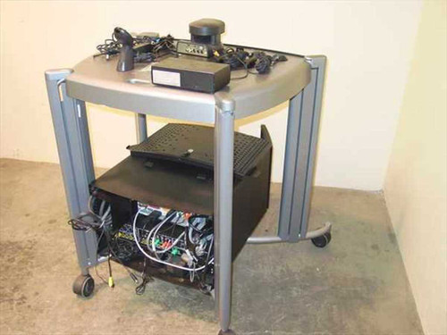 VTEL WG500 video conferencing cart — rear three-quarter view showing cables routed through cart, Sony EVI-D30 camera and control box on top shelf, PC and modem on lower shelf