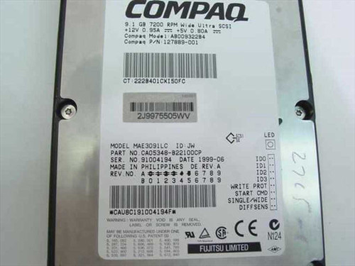 Compaq 127889-001 drive label close-up showing 9.1GB 7200RPM Wide Ultra SCSI specs, Fujitsu MAE3091LC model, part number CA05348-B221DCCP, and manufacture date 1999-06