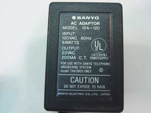 Sanyo 12A-120 AC Adapter label close-up showing model number, 120VAC 60Hz 8W input, 23VAC 200mA output, UL listing, and TRA 9903 compatibility note