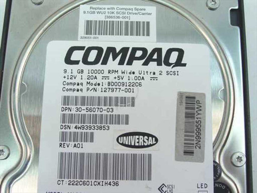 Compaq 127977-001 drive label close-up showing model BD009122C6, 9.1GB 10000 RPM Wide Ultra2 SCSI, +12V 1.20A +5V 1.00A, P/N 127977-001, REV A01