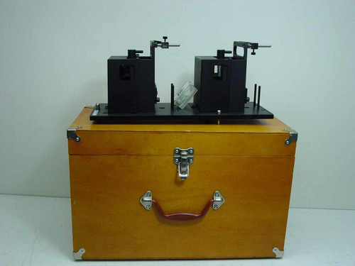 Applied Magnetics EL97083713 AB Alignment Assembly mounted on base plate, resting on top of closed wooden carrying case — front view