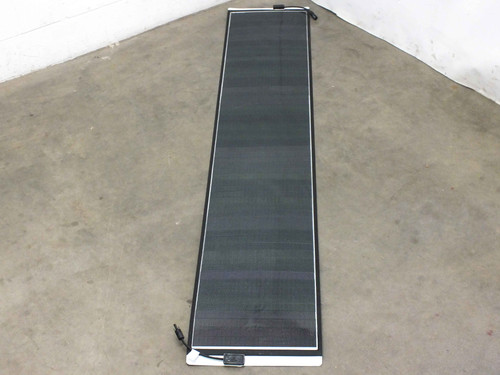 Solopower SP1 60W flexible solar panel laid flat showing full 86.5-inch length and dark CIGS cell surface with MC4 connector wire at bottom edge