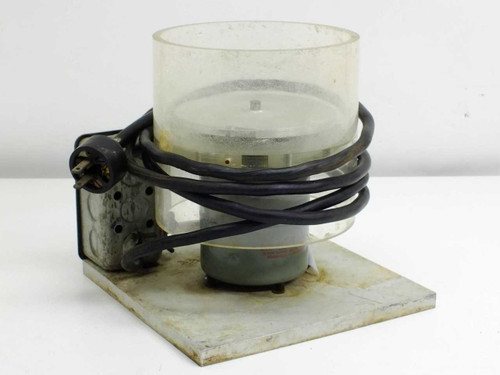 Unbranded spin coater spinner rear/side view showing motor housing, power cord, and clear cylindrical bowl on base plate