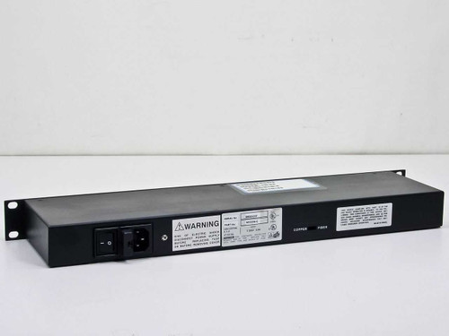 Black Box MX330A-C rear panel view showing IEC power inlet, power switch, warning label, rating plate, and copper/fiber output ports