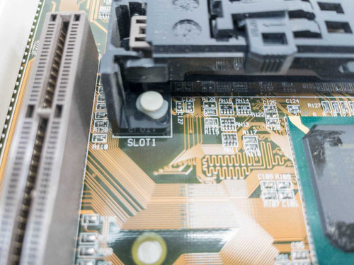 ASUS P2-BX motherboard close-up of Slot 1 CPU socket connector with 'SLOT1' silkscreen label