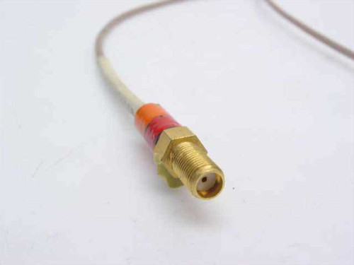 Times Microwave coaxial cable SMA Female connector end close-up showing gold-plated brass body and color-banded strain relief