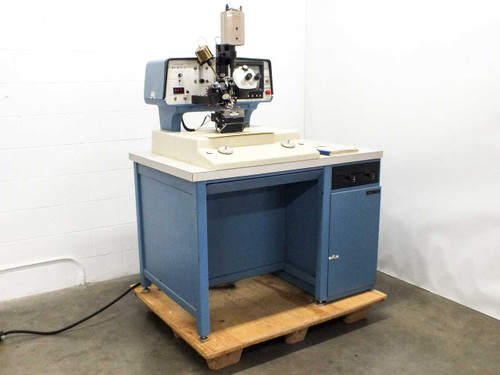 Hughes 2460 HMC-2460 Automatic Wire Bonder System WD-8700D1 – full system front-left view on pallet with integrated blue cabinet