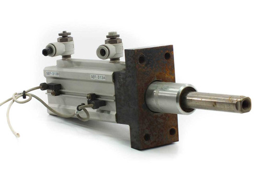 SMC MK2B50L-70-DCK7869K rotary clamp cylinder front-left view showing flange mount plate with surface rust and two push-in pneumatic fittings on top with sensor wires