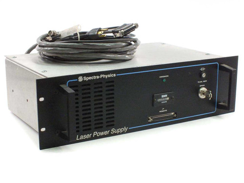 Spectra-Physics R2-740 Laser Power Supply front panel view showing Emission LED, ENM hour meter, J1 Remote D-sub connector, and included cable coiled on top