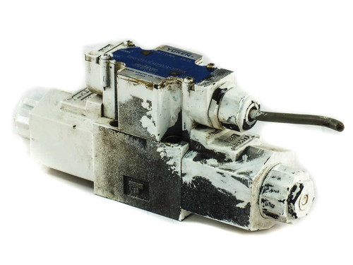 Yuken DSG-01-3C40-D24 directional valve — right-side 3/4 view showing heavy surface wear, chipped paint, solenoid assembly, and manual override pin