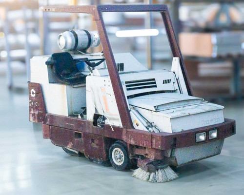 PowerBoss TSS/90-HD-HC rideable sweeper scrubber — left front three-quarter view showing side brush, ROPS frame, and overall machine condition