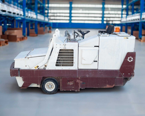 PowerBoss TSS/80-HD riding sweeper scrubber — left side profile view showing full body, operator seat area, and rear wheel in warehouse