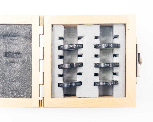 Six CVI Laser NIR bandpass filters in foam-lined wood case showing individual filter slots labeled F10-750 through F10-1000