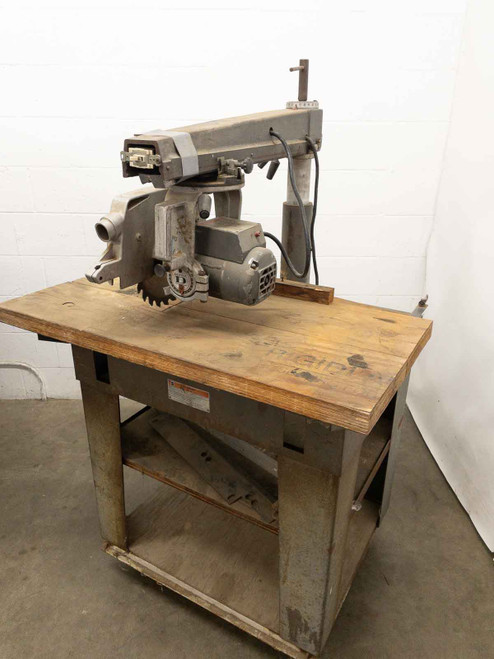 DeWalt 7790 radial arm saw with work table – right-side three-quarter view showing full machine on stand