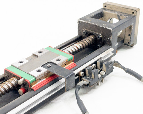 Hiwin KK60 linear stage close-up of ball screw, green-and-red linear guideway carriage, and limit switch wiring