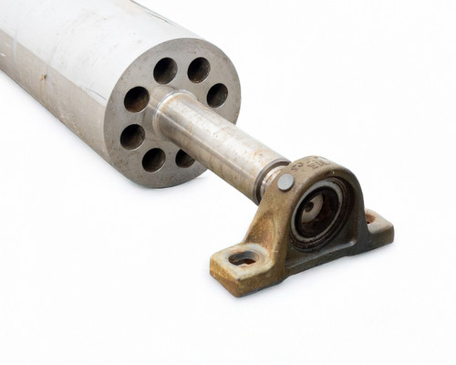 Close-up of roller end showing INA GG.ASE06 pillow block bearing with weathered cast housing and stainless shaft