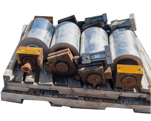 Close angle view of conveyor drum lot on pallet showing hydraulic brake blocks and galvanized drum surfaces