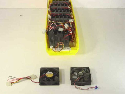 Yellow storage bin holding approximately 30 Sunon 12V 80mm case cooling fans with mixed wiring, with two fans displayed in front showing 4-pin Molex and 3-pin connectors