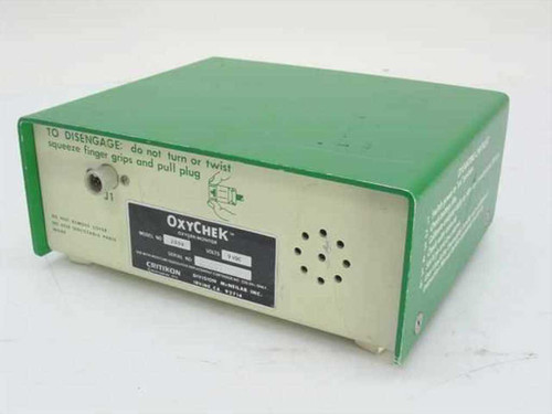 Critikon OxyChek 2000 Oxygen Monitor rear panel view with rating plate label, ventilation holes, and sensor plug port