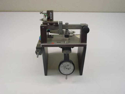 SMC pneumatic tolerance checking fixture front view showing analog dial indicator gauge mounted below linear slide assembly
