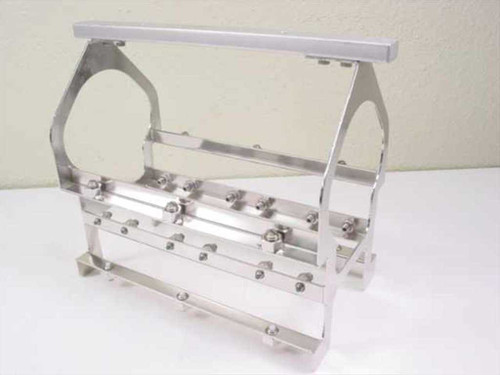 Applied Magnetics NL Block Carrier – front three-quarter view showing polished aluminum frame, cylindrical spool cradle, and rows of adjustment bolts