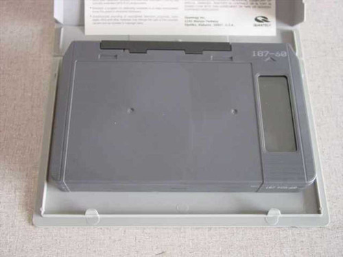 Quantegy 187-KCA60 U-Matic tape cartridge removed from case, showing top of grey plastic cassette shell with model number 187-60 visible, inside open box with paperwork