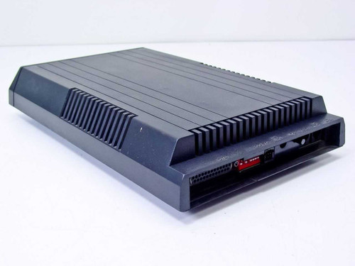Microcom AX/9600 Plus external modem – rear-left angle showing port panel with DIP switches and connectors