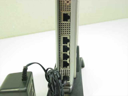 Netgear MR814 wireless router rear panel showing 1 WAN RJ-45 port and 4 LAN RJ-45 ports with power adapter connected