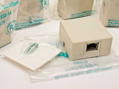 Premier PT-625A2-8SB-44 surface mount wall jack unboxed showing ivory housing, RJ-45 port, mounting screws, and wall plate on white background