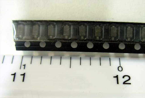 BZT52C30 SOD-123 Zener diodes on original tape-and-reel strip, approximately 10 units visible next to ruler