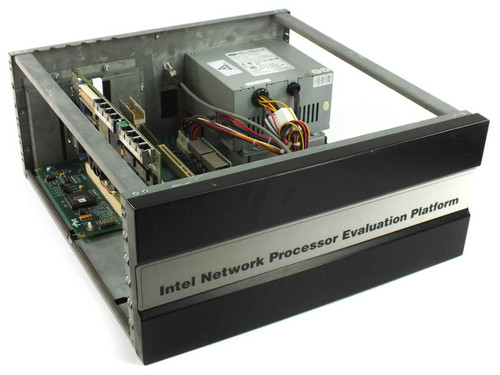 Intel Network Processor Evaluation Platform KEIXP12EBAA — three-quarter front view showing brushed-metal faceplate label and open chassis with internal PCI backplane and power supply