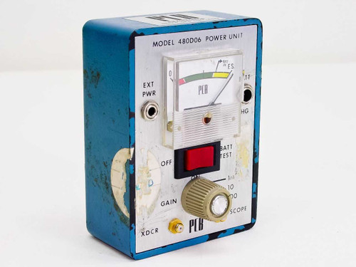 PCB Piezotronics 480D06 Power Unit front panel showing analog meter, GAIN knob, BATT TEST switch, XDCR connector, and EXT PWR jack — blue enclosure with heavy wear